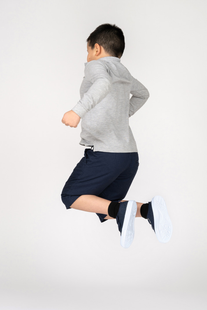 Side view of a jumping boy