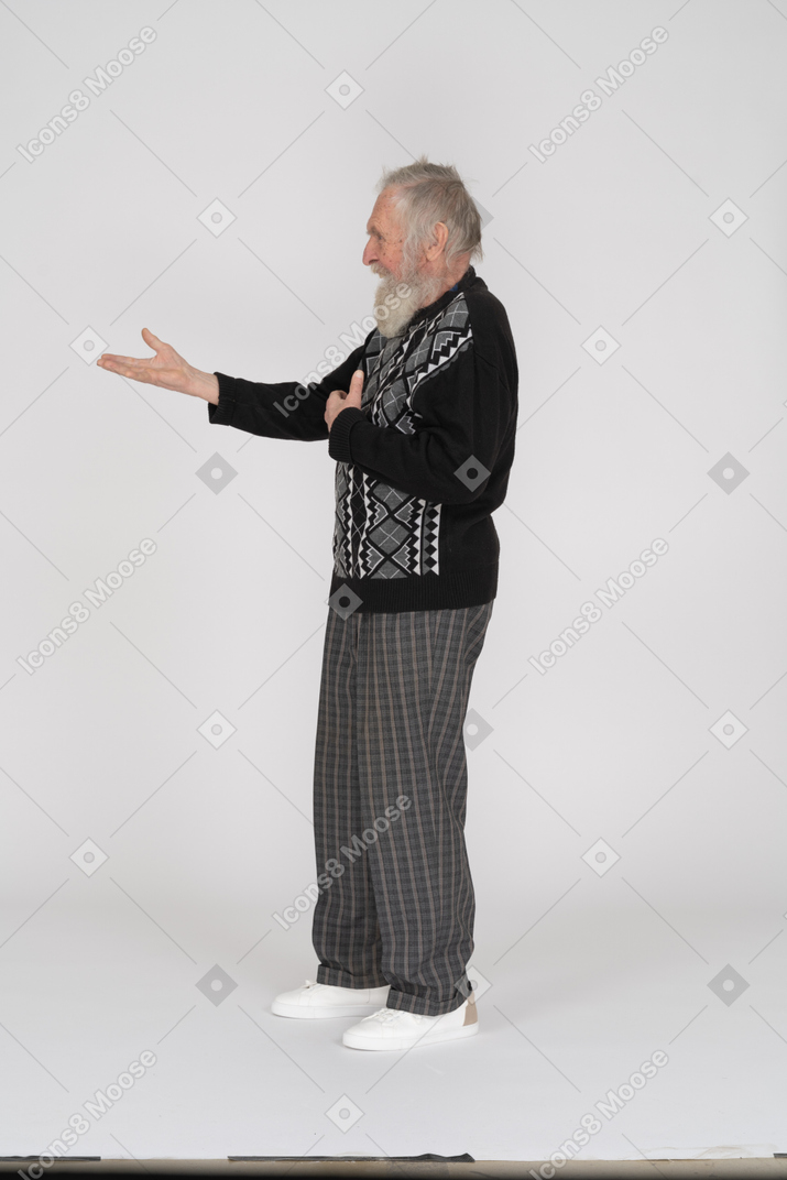 Smiling elderly man outstretching his arm