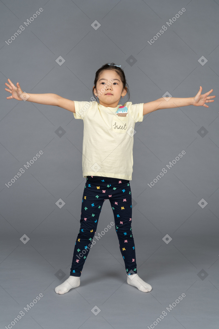 Girl standing with spread hands