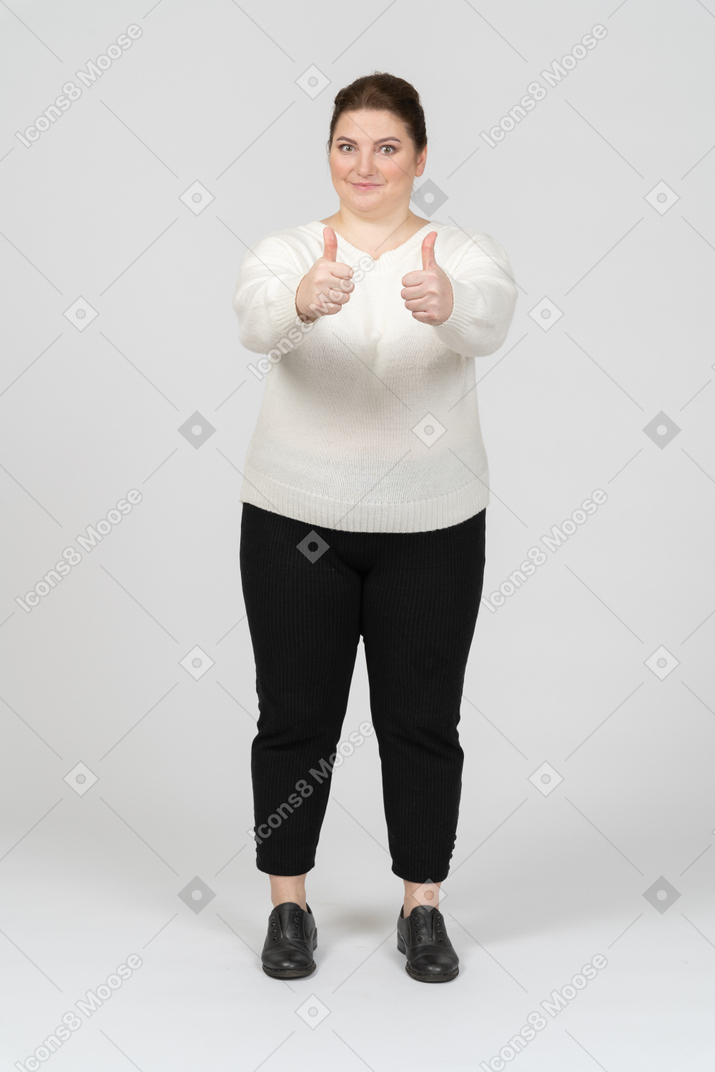 Plus size woman in white sweater showing thumbs up