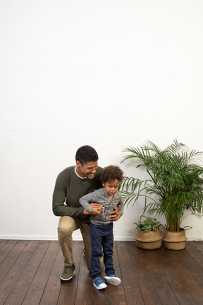 Good looking young man on knees with a boy