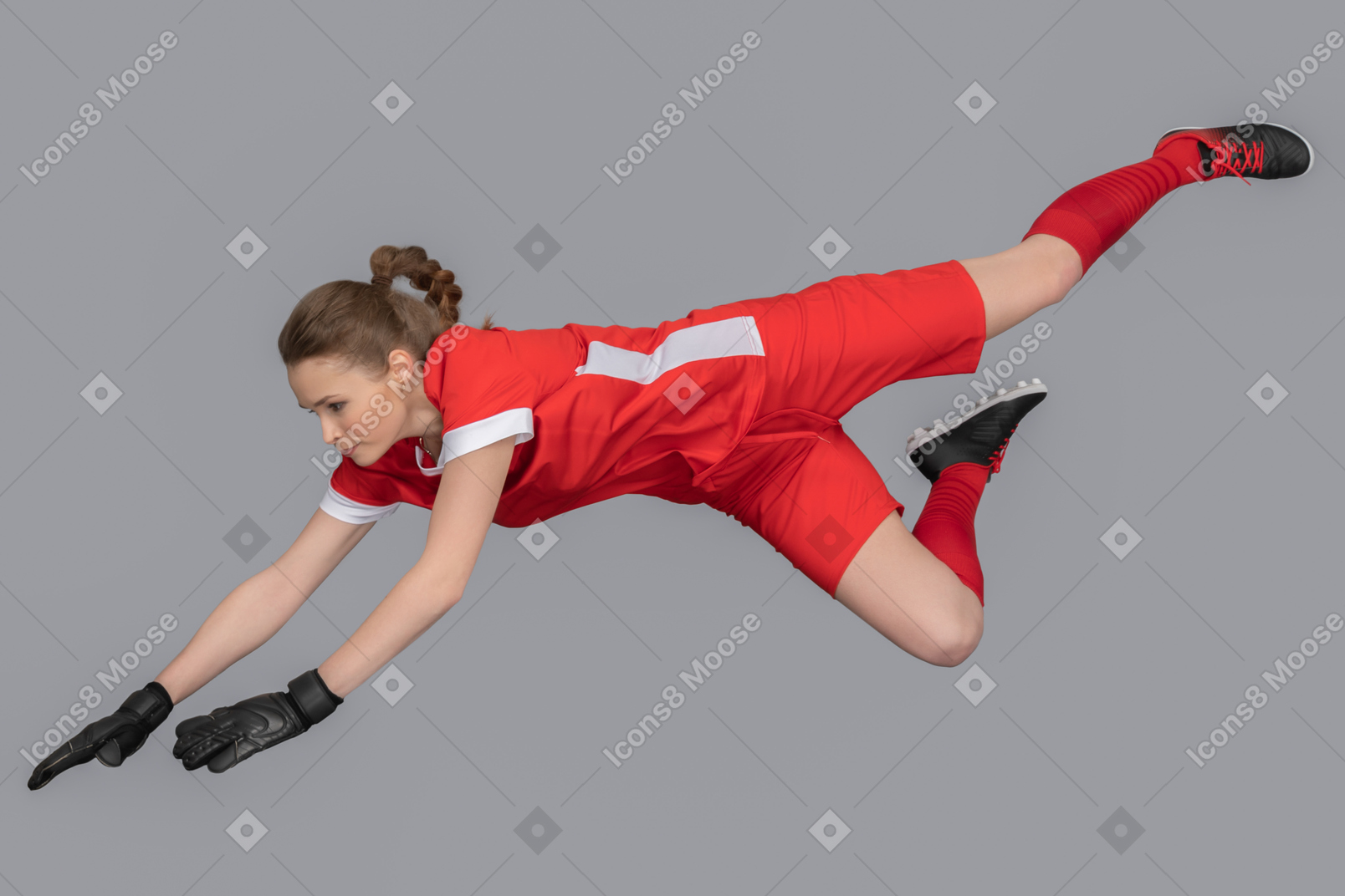 A female goalkeeper in the air