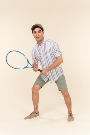 Young caucasian man holding tennis racket