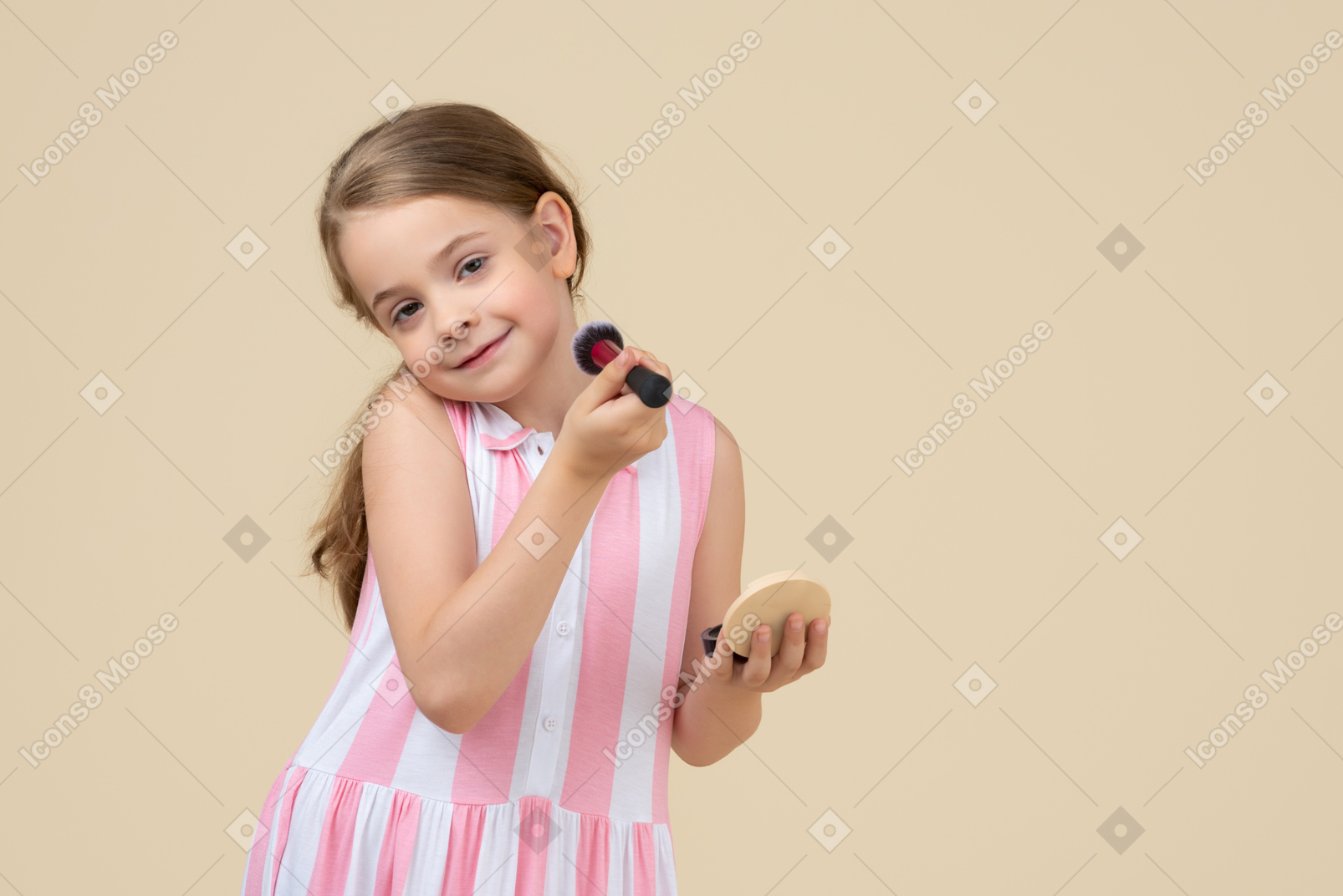 Cute little girl applying makeup