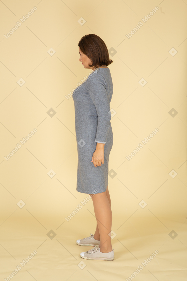 Side view of a woman in grey dress
