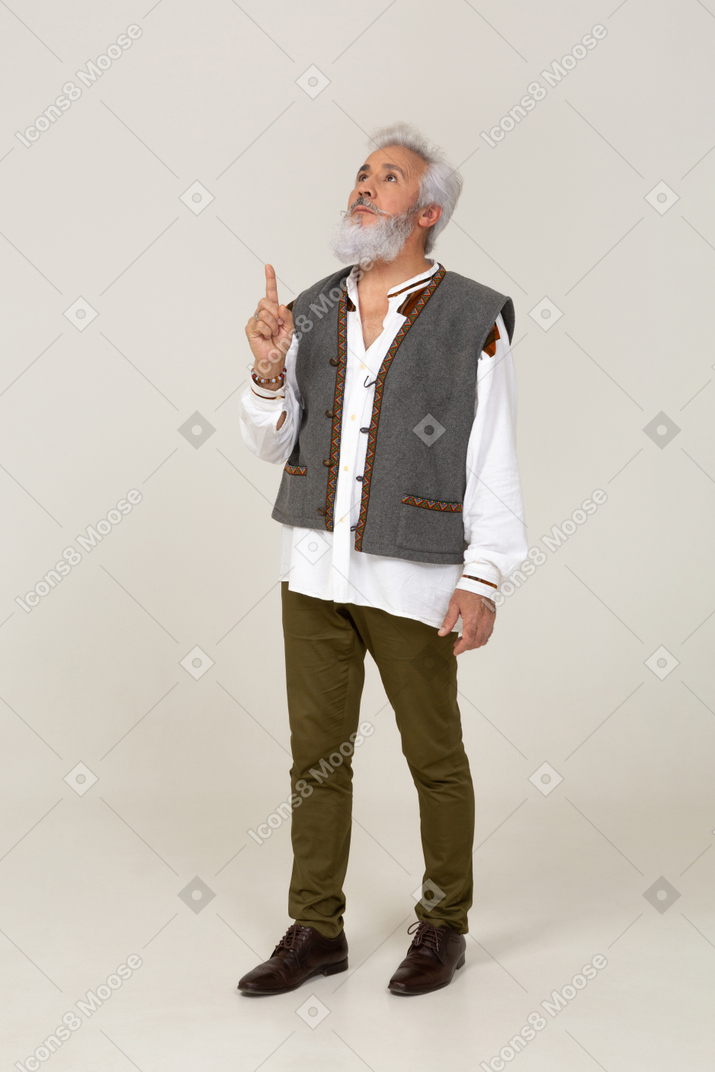Man in gray vest raising his finger
