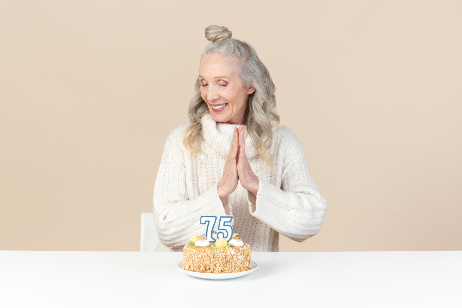 Old woman clapping hands for her seventy fifrth birthday