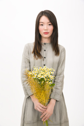 Girl holding a bouquet of wild flowers