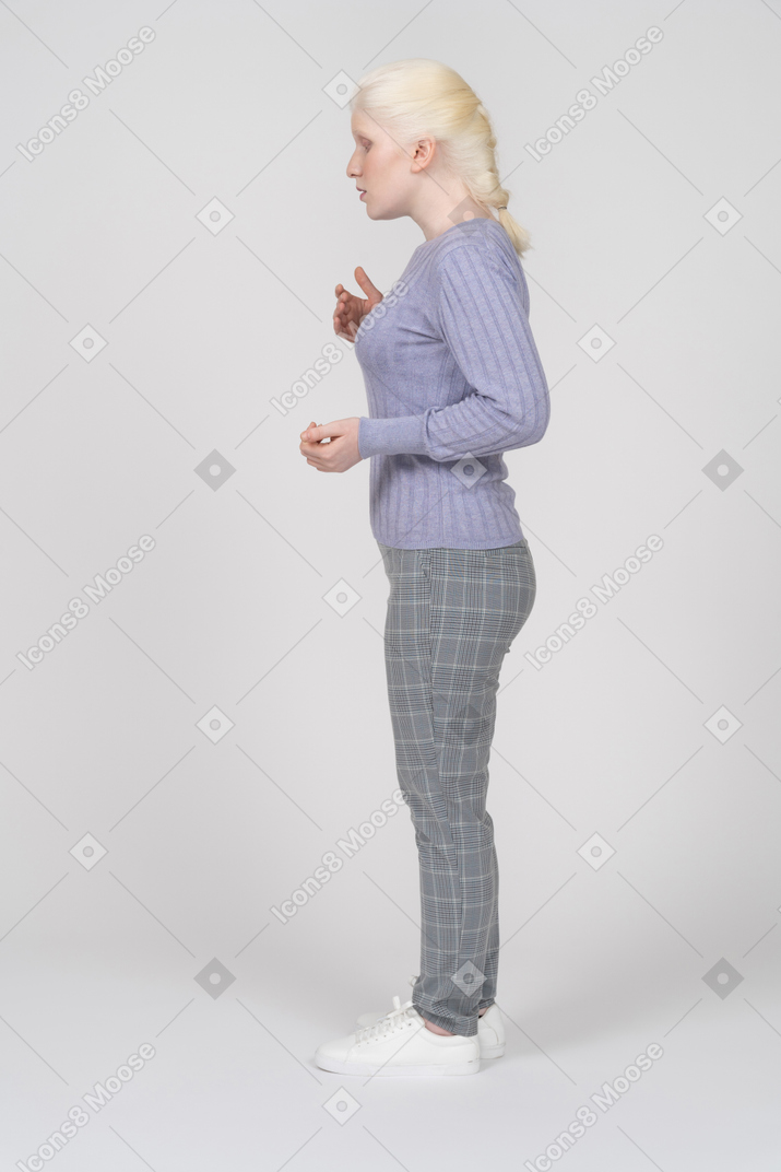 Side view of young woman gesturing
