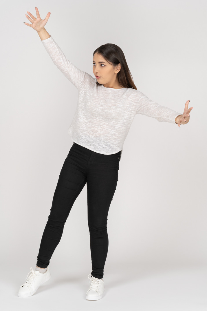 Three-quarter view of a young indian female wearing casual clothes showing size of something huge