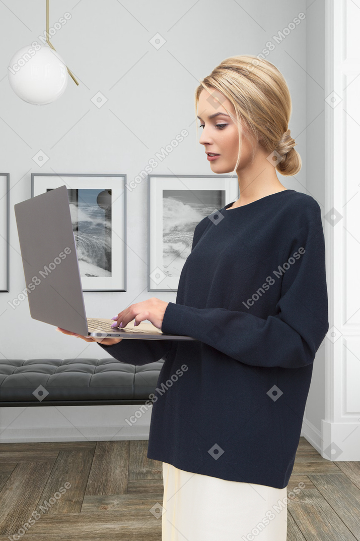 A woman is using a laptop in a living room