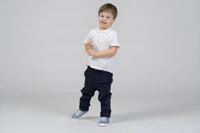 Front view of a cheerful little boy