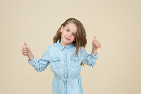 Cute little girl showing thumbs up