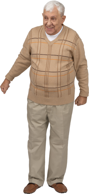 Front view of a happy old man in casual clothes standing with clenched fists