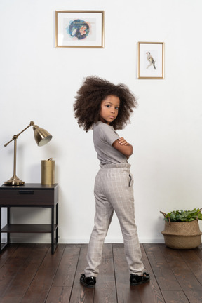 Good looking girl kid posing on the apartment background