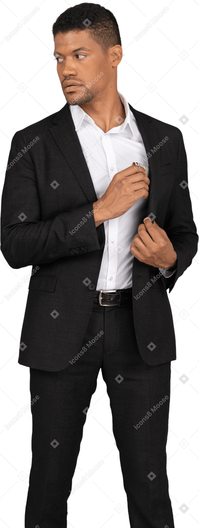 Front view of a young man in black suit holding bank card