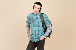 Student standing with a backpack and headphones