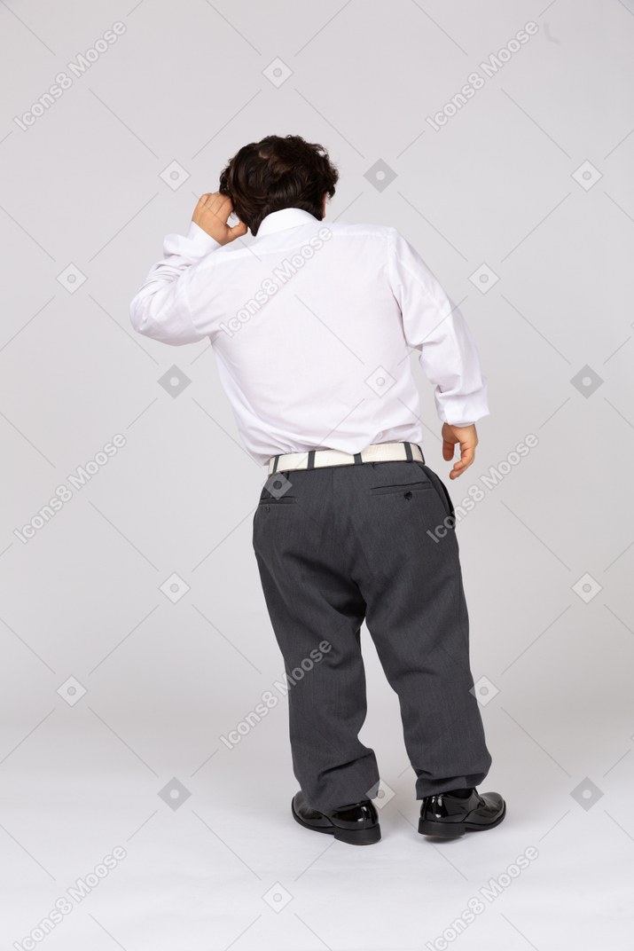 Back view of an office worker holding a hand to his ear