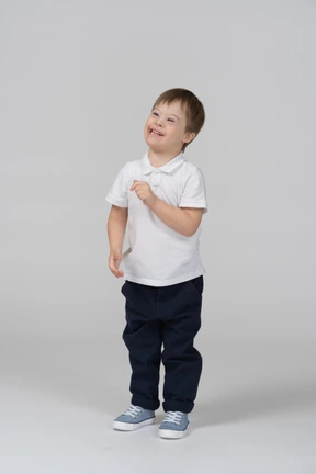 Happy little boy raising his arm