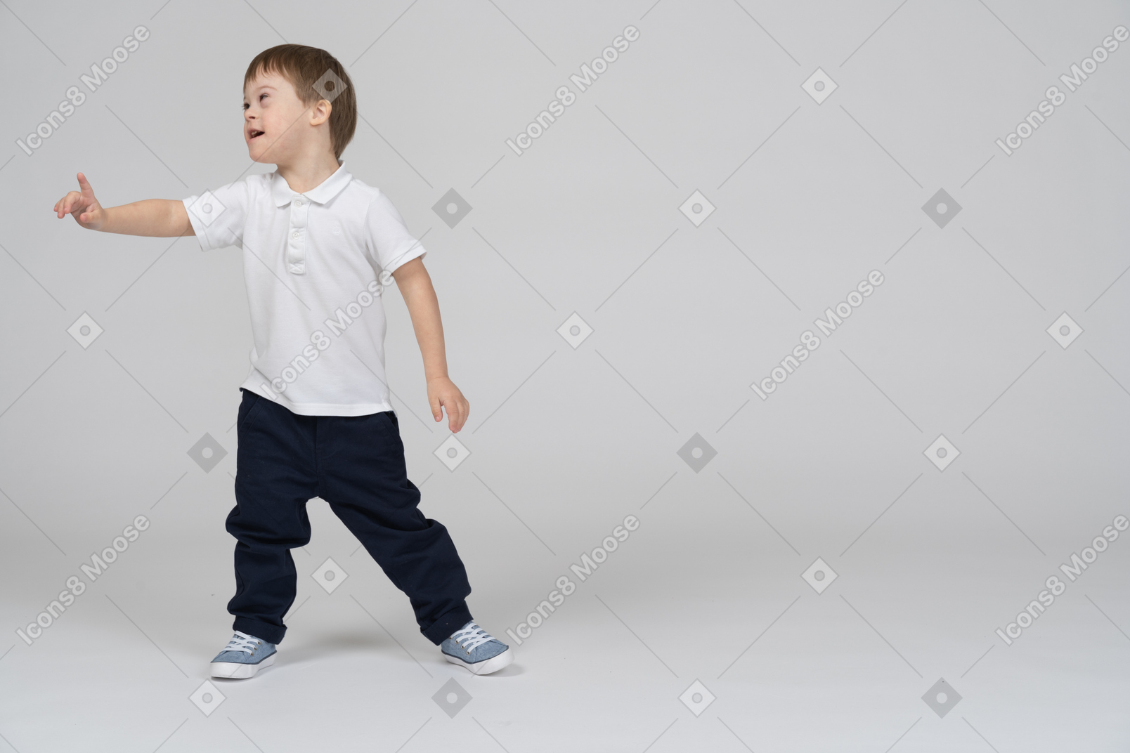 Little boy pointing up and looking aside