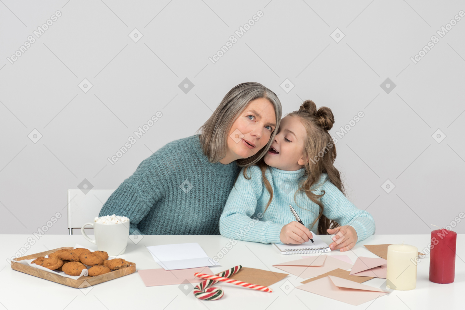 Grandmother and granddaughter writing a letter to santa together