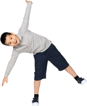 Boy with spread arms looking at camera