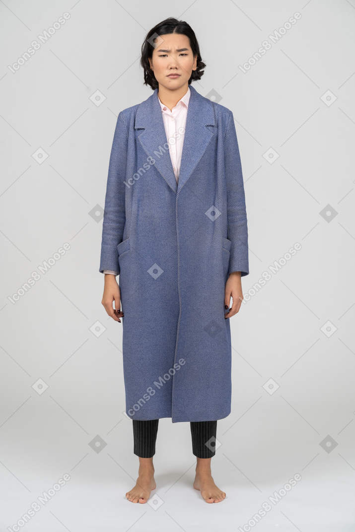 Front view of an upset woman in blue coat