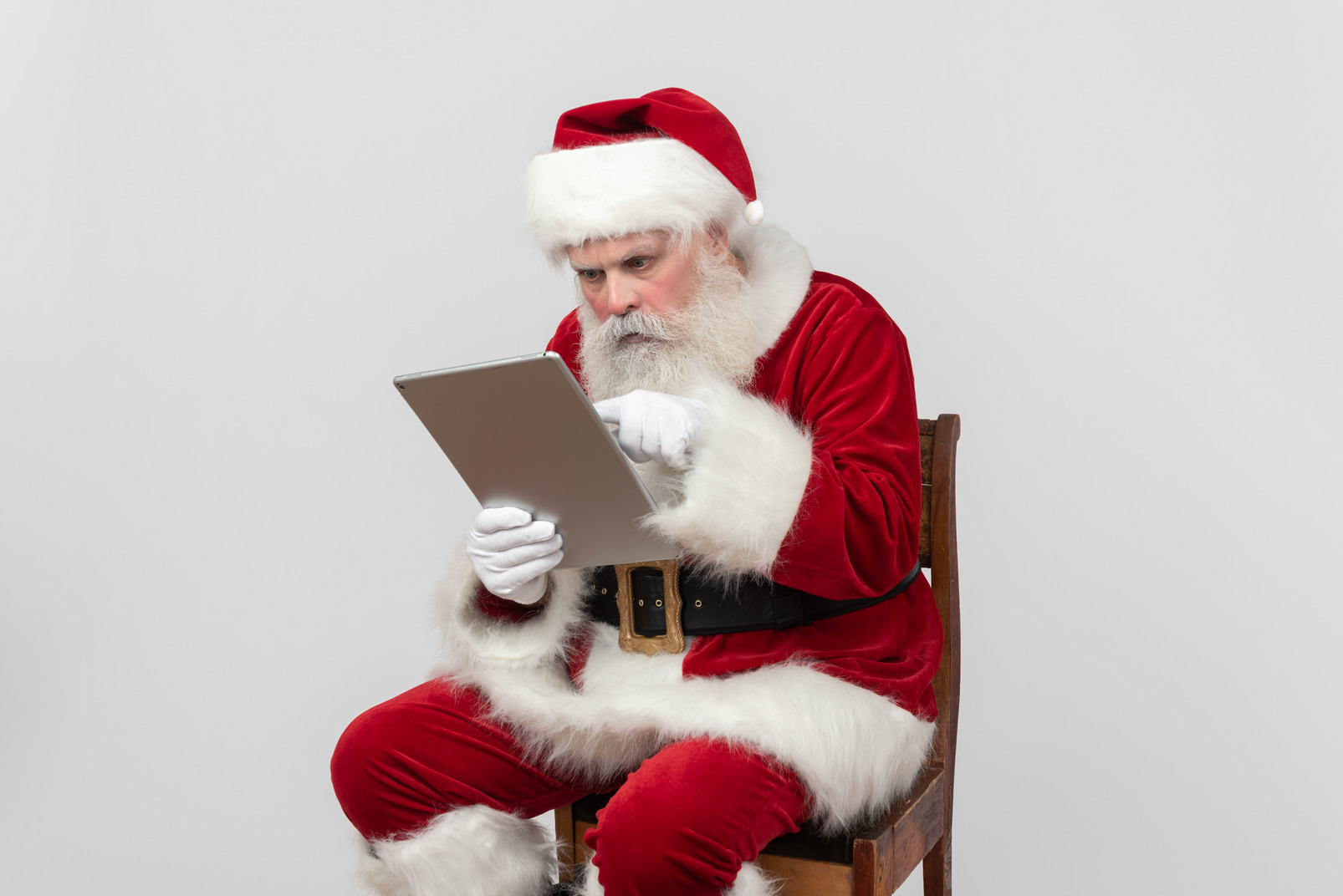 Santa claus focused on reading information on folder