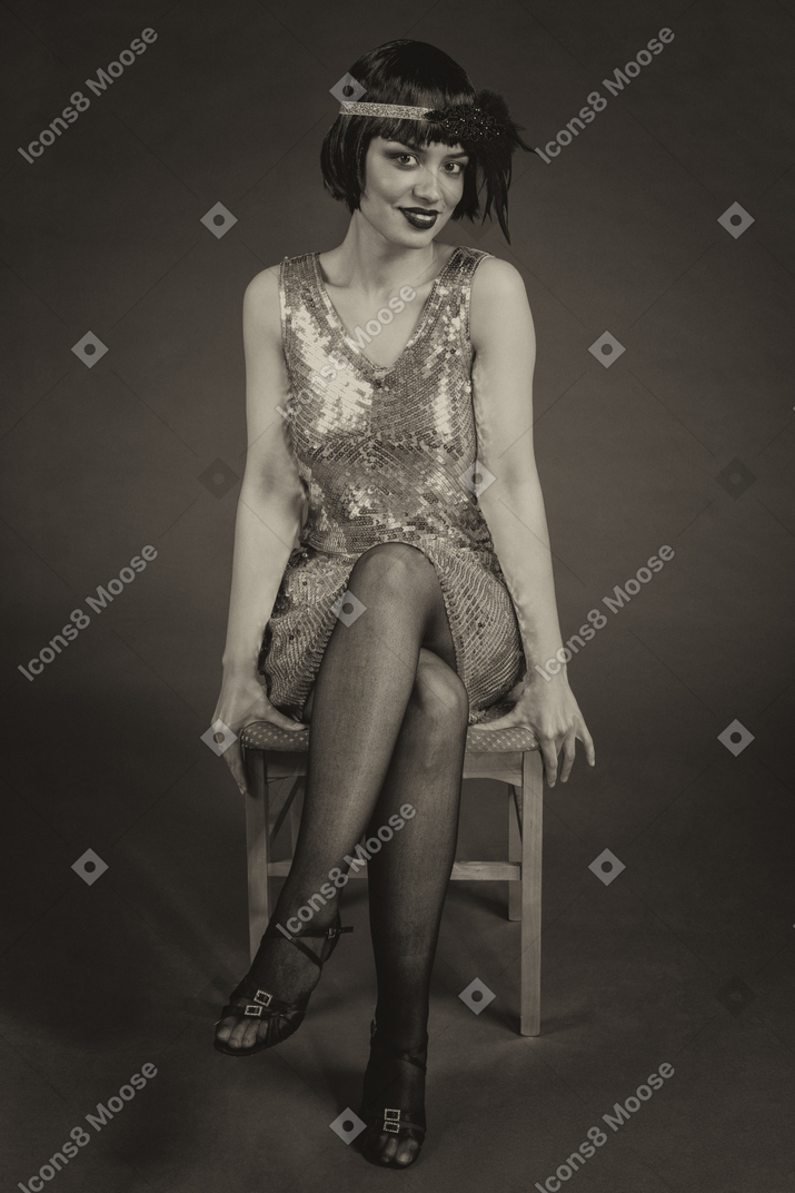 Beautiful american flapper sitting leg to leg on the chair