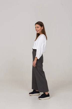 Three-quarter view of a winking young lady in office clothing