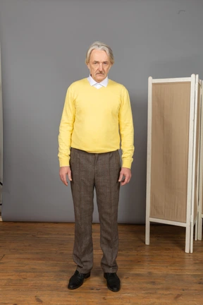 Front view of a serious old man looking at camera