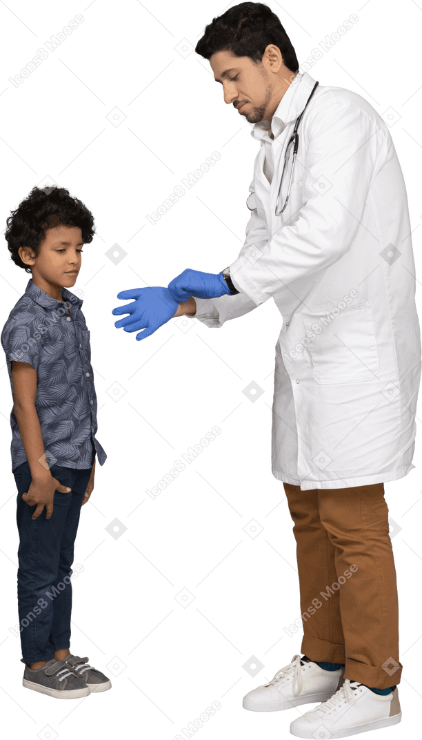 Boy looking at doctor's hands