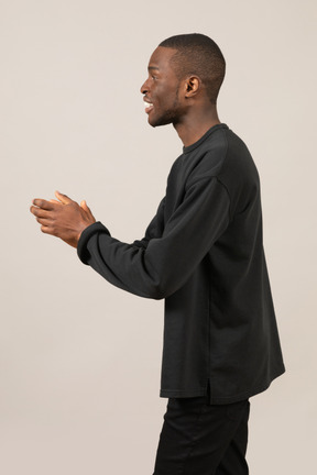 Side view of young man talking