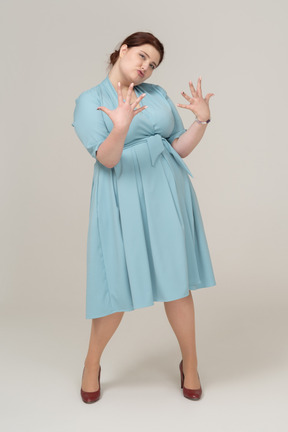 Front view of a woman in blue dress gesturing