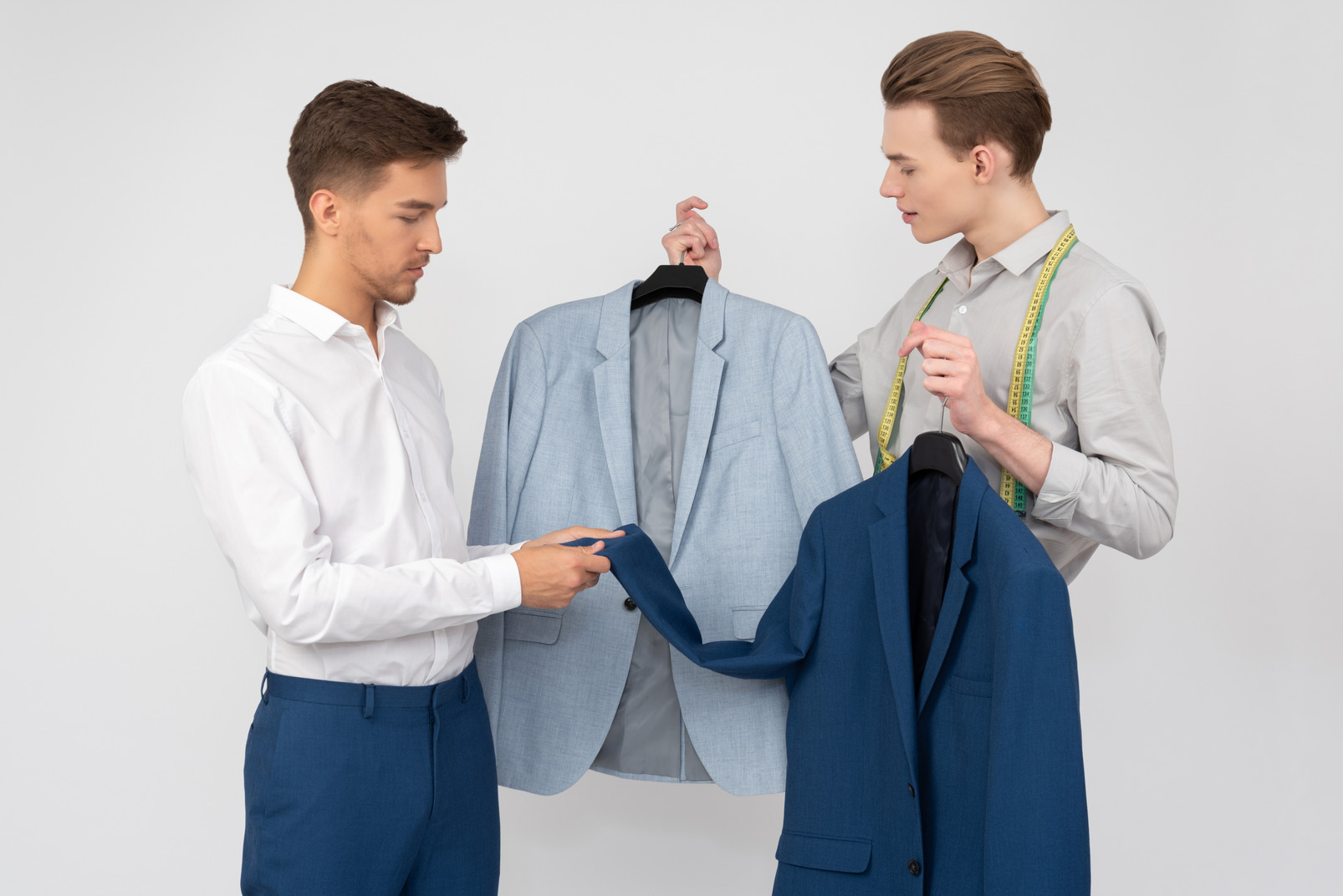 Young tailor offering two options to his customer