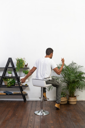 Good looking young man sitting on a chair