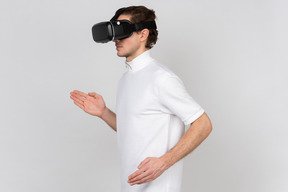 Young man in virtual reality headset doing robot dance moves