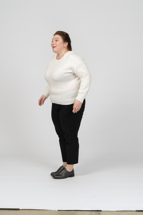 Side view of a plump woman in white sweater