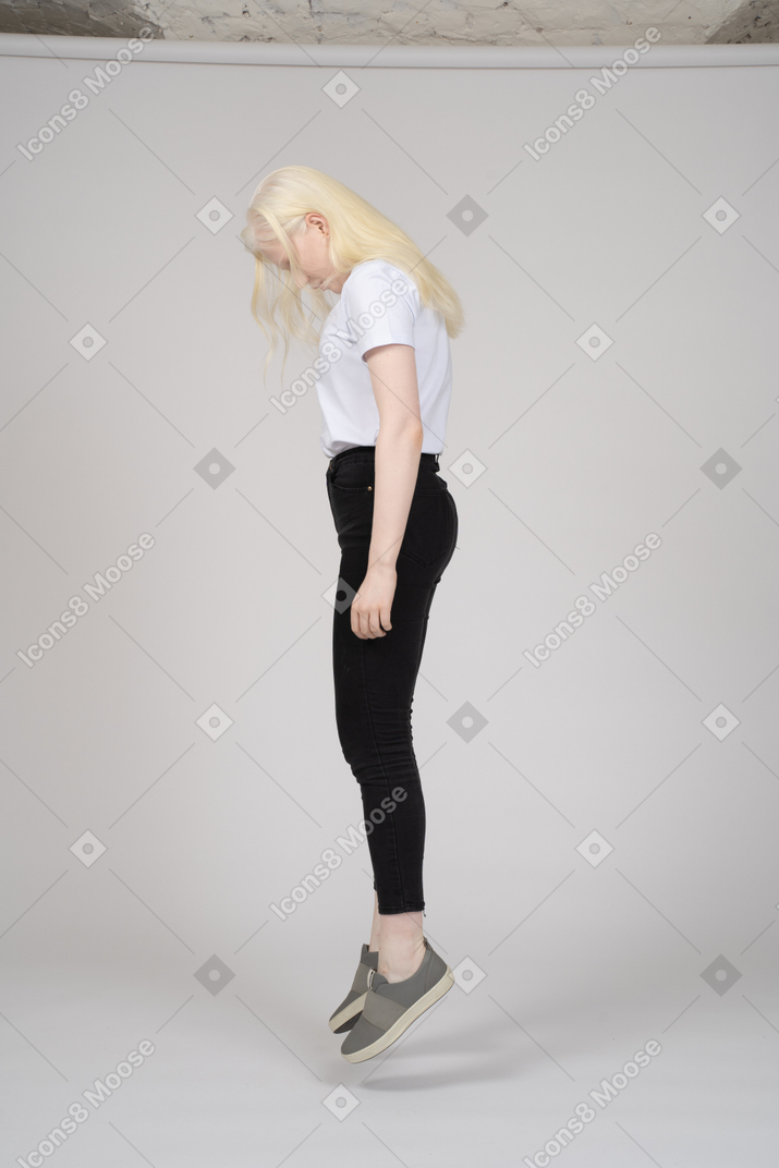 Side view of girl levitating with head down