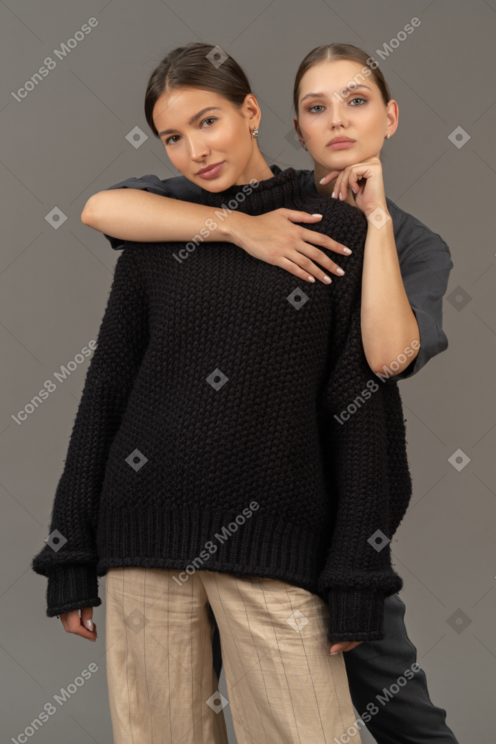 Two woman standing and embracing