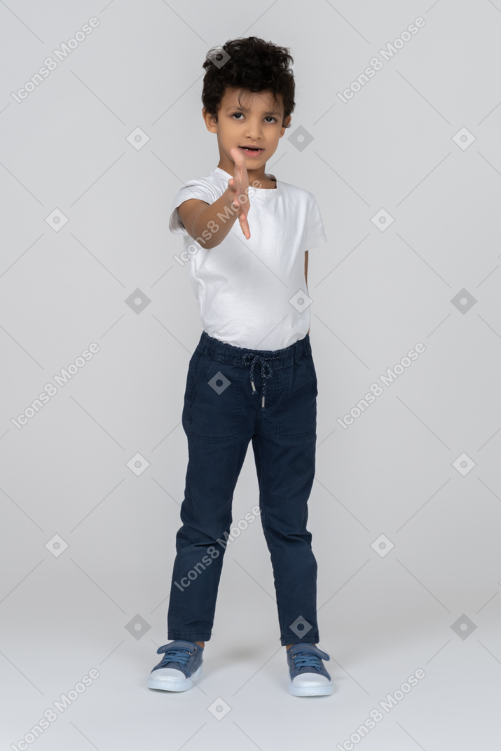 A boy going to shake hands with you