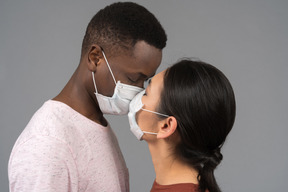 A young couple wearing face masks