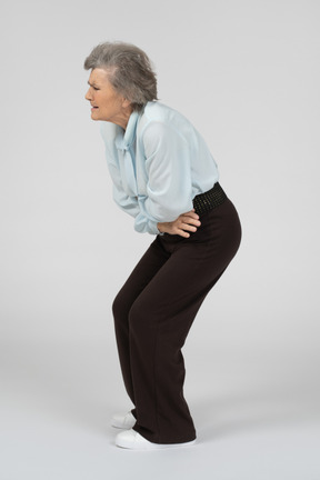 Old woman having stomach ache