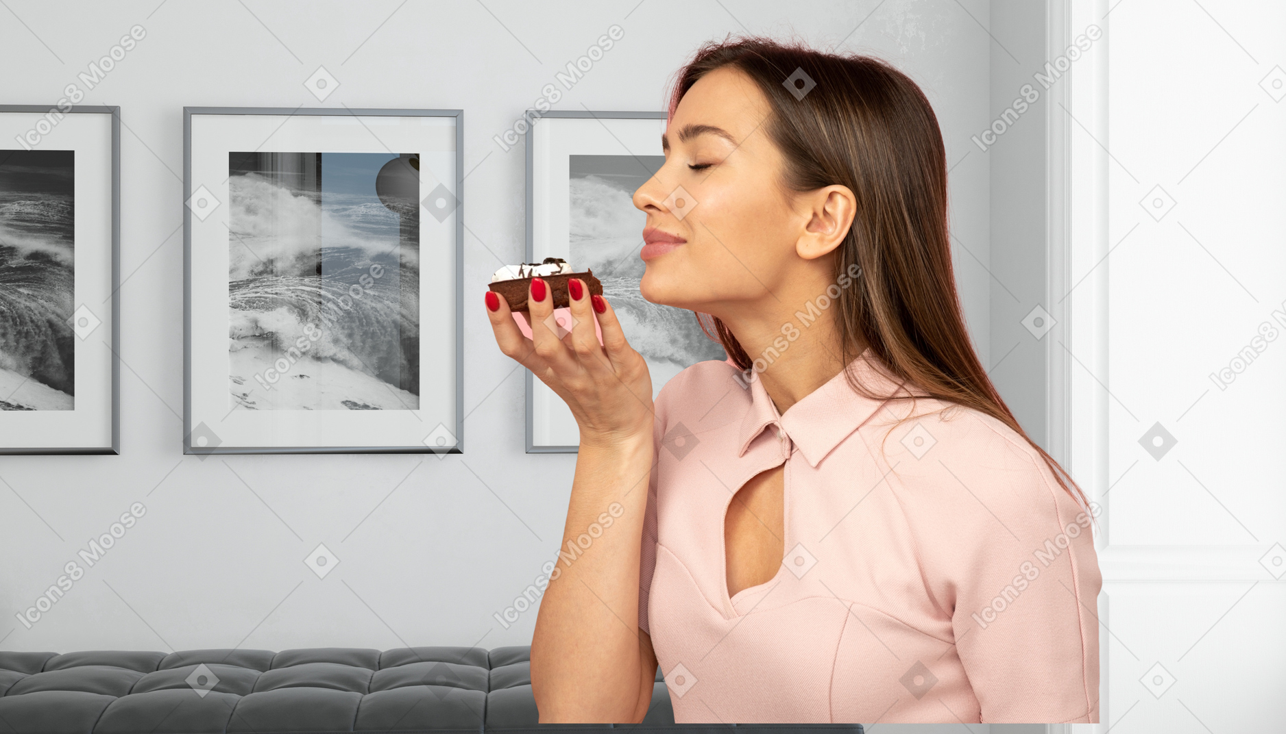 A woman smelling a piece of cake in her hand