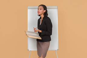 Attractive afro woman standing by the whiteboarding