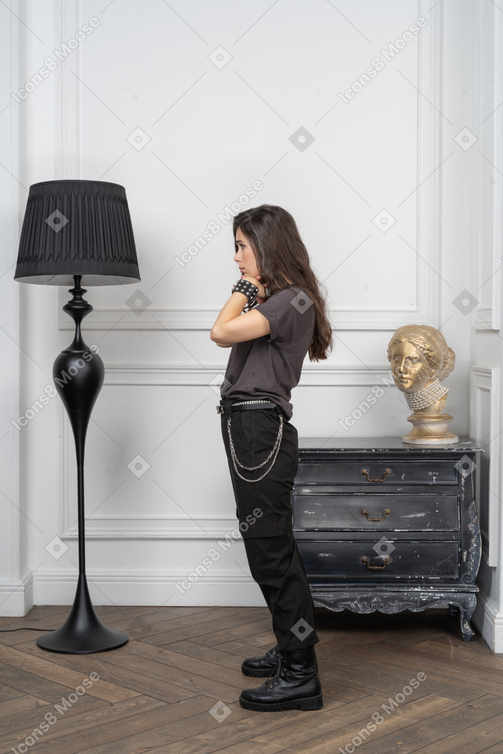 Side view of a miserable female rocker putting hands under her chin