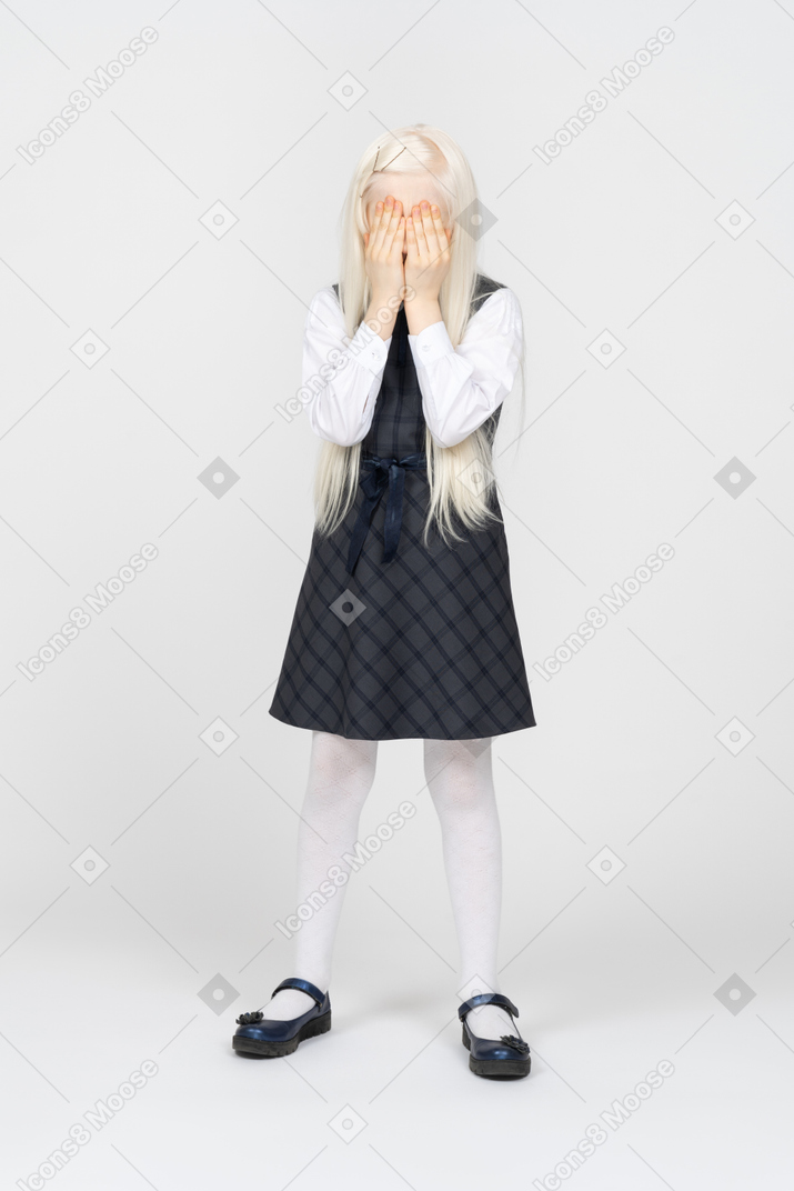 Schoolgirl hiding her face