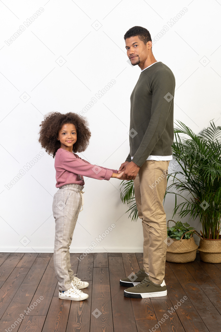 Father and daughter hold hands