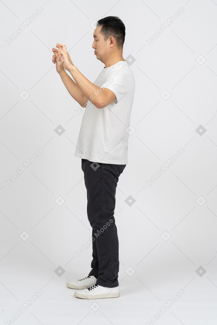 Side view of a man with crossed fingers