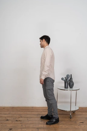 Man in casual clothes standing in profile